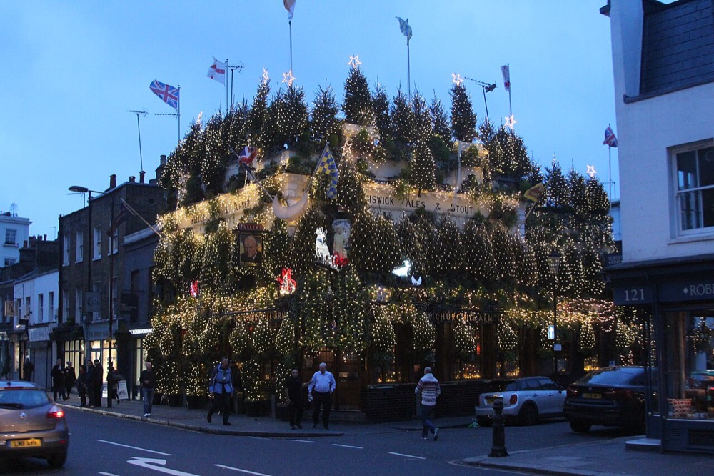 The flower-covered exterior of The Churchill Arms pub in Kensington, London — photo 1