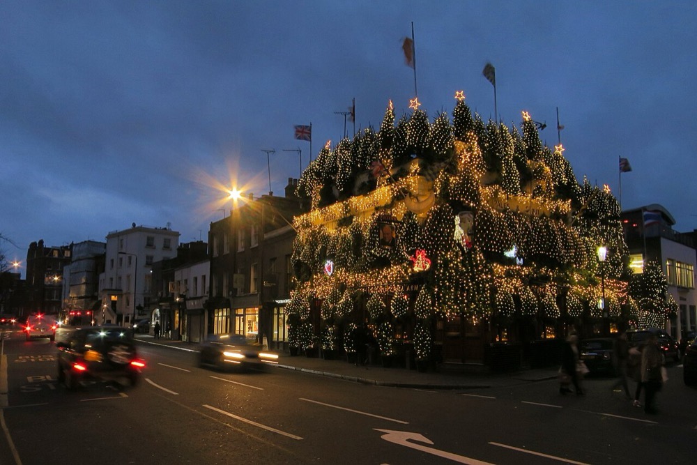 The flower-covered exterior of The Churchill Arms pub in Kensington, London — photo 2
