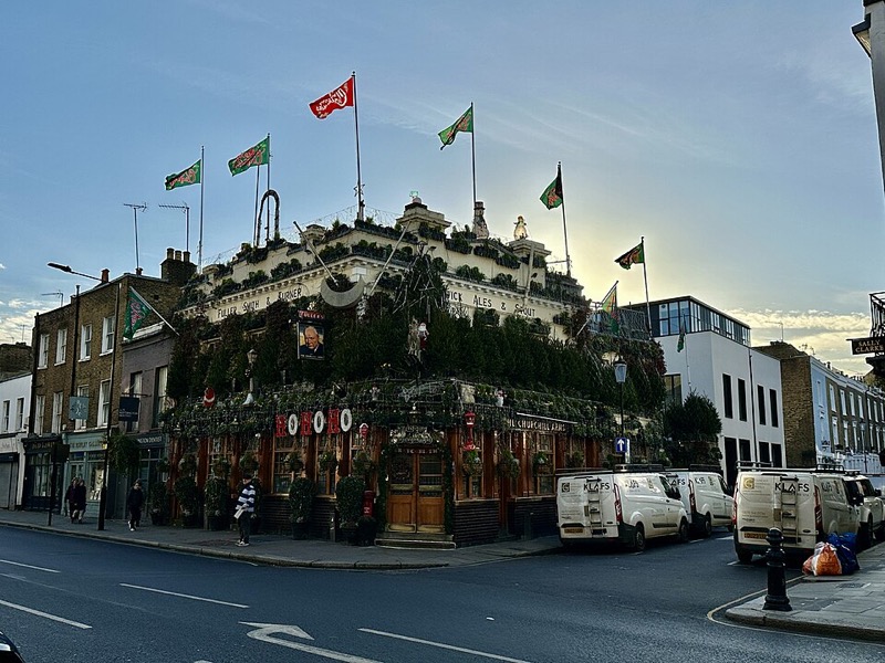 The flower-covered exterior of The Churchill Arms pub in Kensington, London